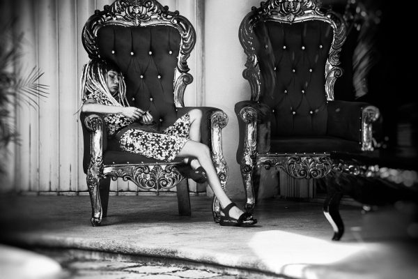 A bored girl relaxes in front of a boutique with luxury lingerie at noon. Just a few blocks away, a slum begins. I was sitting a little further down, drinking a beer. She barely moved the whole time.