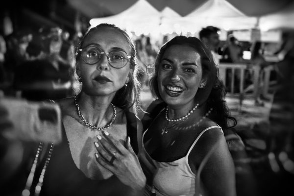 Midsummer night, stormy celebrations, two women taking selfies and me taking pictures of them. One is flattered, the other not so much, but after a while she introduces herself as Veronica and tells me to go have fun with them. I don't. I can't.