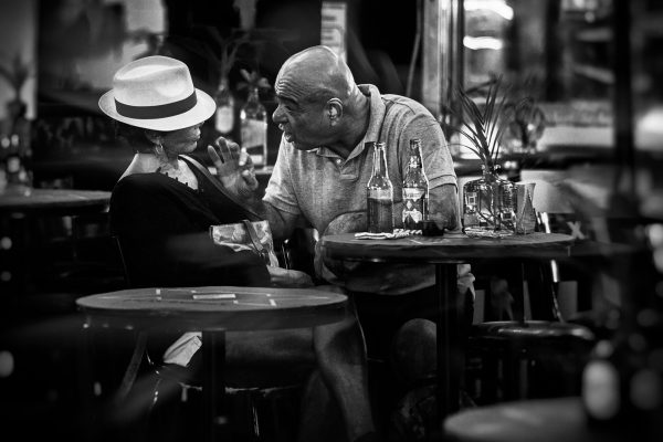 It's noon, I'm sitting on Fifth Street, sweating, having a salty beer and watching an older couple a few tables away. The man keeps shouting something, the woman is stoically silent, provoking. I'm sorry I don't speak French, I couldn't understand a word he said.